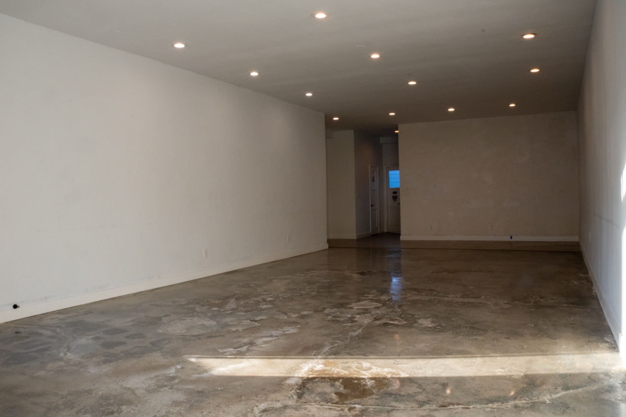 Wide view of the vacant 3815 W. Sunset Blvd. interior looking toward the rear of the suite, showing the full depth of the room.